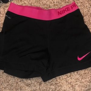 Black nike pros with pink band